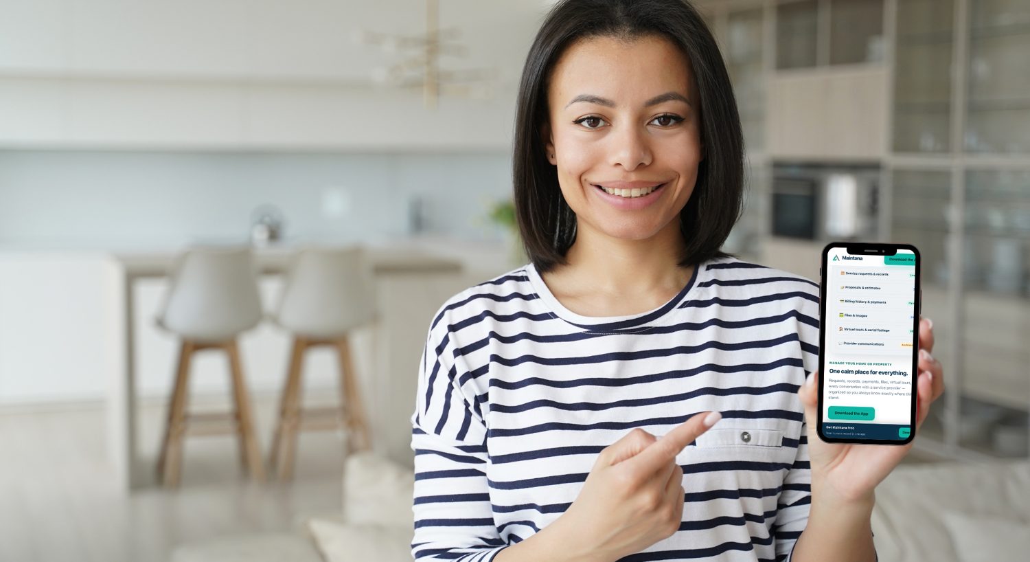 A property owner showing the Maintana app on her phone