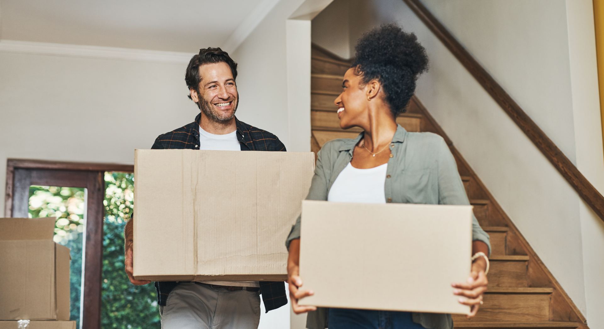 A happy couple moving into their new home